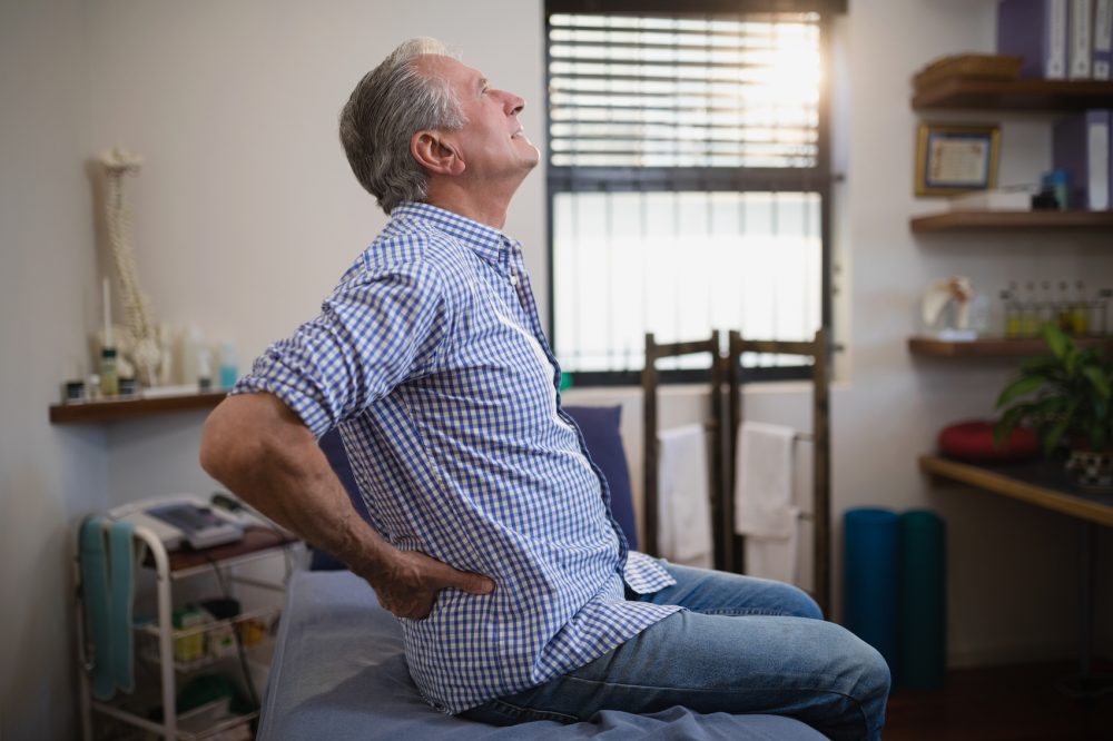 Elderly man having hip and lower back pain